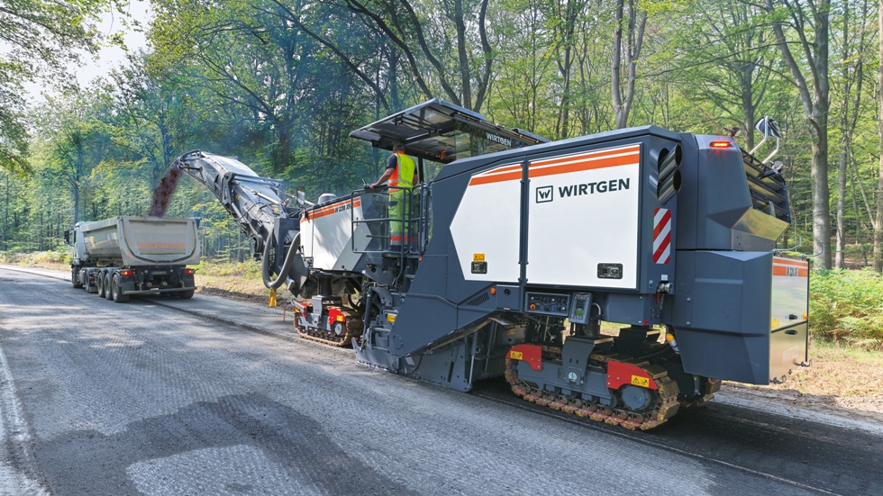 Milling machine loading reclaimed asphalt onto a truck