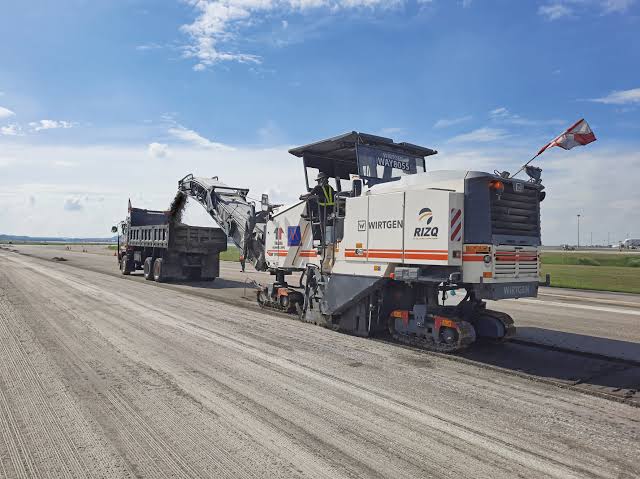 Paving train working on an airport runway